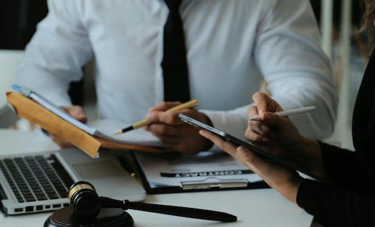 Documents, a laptop and a judge's gavel on a desk during a legal review